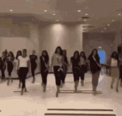 A Blurred Image Of A Group Of Women Dancing In A Room GIF