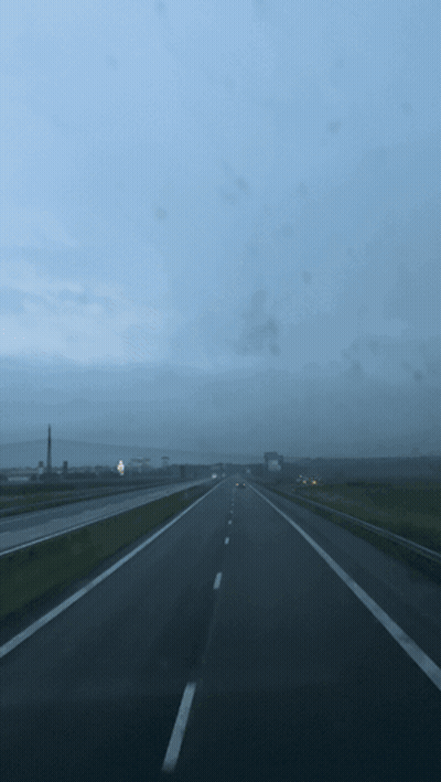 A Blurred Image Of A Highway With A Blue Sky GIF