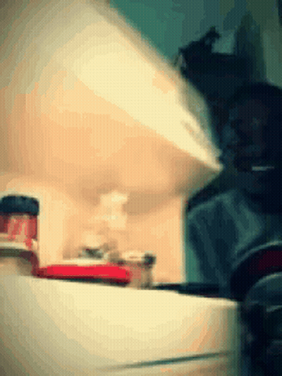 A Blurred Image Of A Kitchen With A Bottle Of Ketchup On The Counter GIF