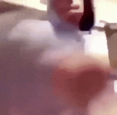A Blurred Image Of A Man In A Suit And Tie GIF