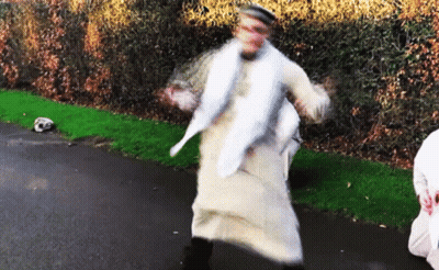 A Blurred Image Of A Man In A White Robe Dancing GIF