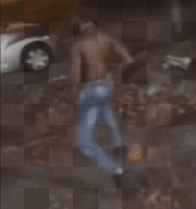 A Blurred Image Of A Man Standing In Front Of A Car GIF