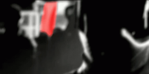 A Blurred Image Of A Man With A Red Tie In The Foreground GIF
