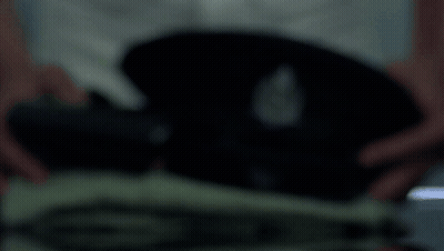 A Blurred Image Of A Person Holding A Black Object In Their Hands GIF