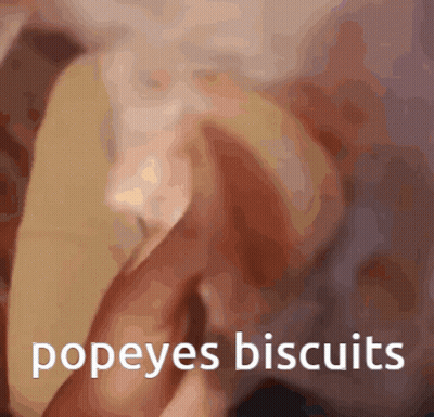 A Blurred Image Of A Person Holding A Popeye 'S Biscuit GIF
