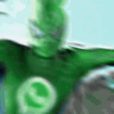 a blurred image of a person in a green costume