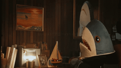 A Blurred Image Of A Person Looking At A Picture On A Table GIF