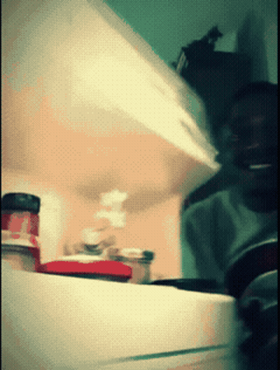A Blurred Image Of A Person Opening A Fridge GIF