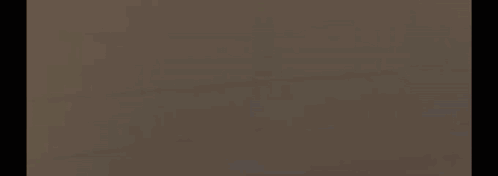 A Blurred Image Of A Person 'S Face With A Brain Logo In The Background . GIF