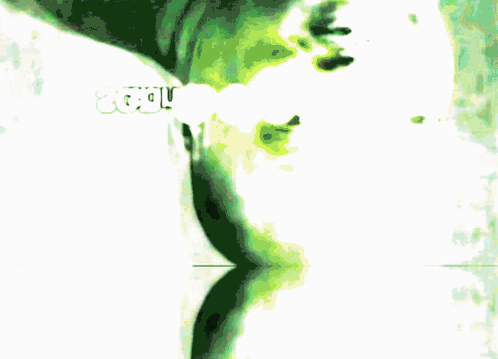 A Blurred Image Of A Person 'S Face With A Green Background GIF