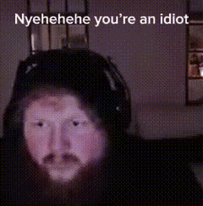A Blurred Image Of A Person 'S Face With The Words Nyehehe You 'Re An Idiot Written Above It . GIF