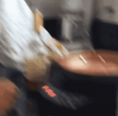 A Blurred Image Of A Person 'S Hand Holding A Piece Of Paper That Says ' Aa ' GIF