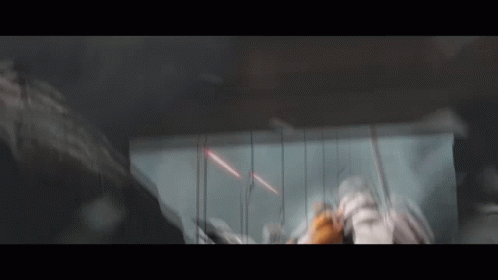 A Blurred Image Of A Person Standing In A Dark Room With A Sword . GIF