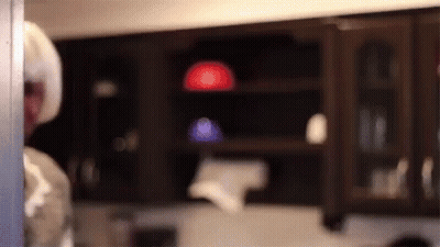 A Blurred Image Of A Person Standing In A Kitchen . GIF