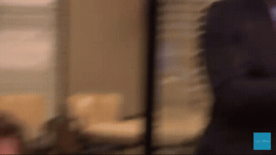 A Blurred Image Of A Person Standing In Front Of A Sign That Says " Be The One " GIF