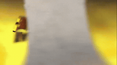 A Blurred Image Of A Person Standing Next To A White Object . GIF