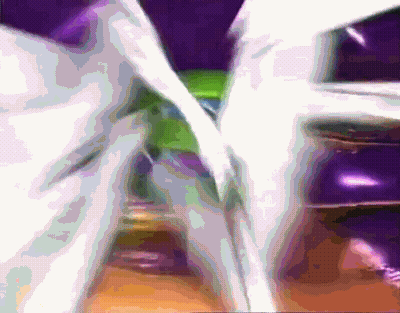 A Blurred Image Of A Purple And Green Colored Object GIF