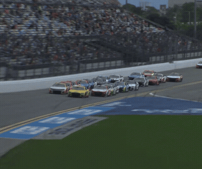 A Blurred Image Of A Race Track With A Sign That Says ' Georgia ' GIF