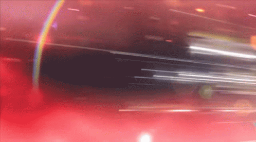 A Blurred Image Of A Red Background With A Rainbow In The Middle GIF