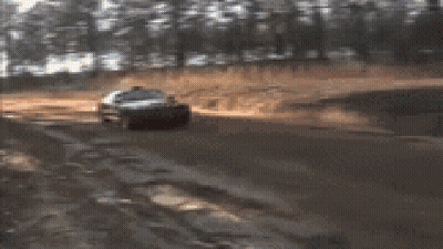 A Blurred Image Of A Red Car With A License Plate That Says ' Nc ' On It GIF