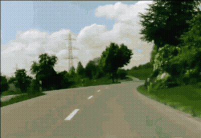A Blurred Image Of A Road With Trees On The Side Of It GIF