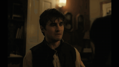 A Blurred Image Of A Room With A Lamp And Curtains GIF