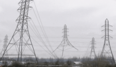 A Blurred Image Of A Row Of Power Lines And Towers GIF