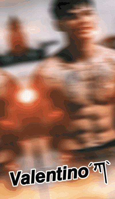 A Blurred Image Of A Shirtless Man With The Name Valentino GIF