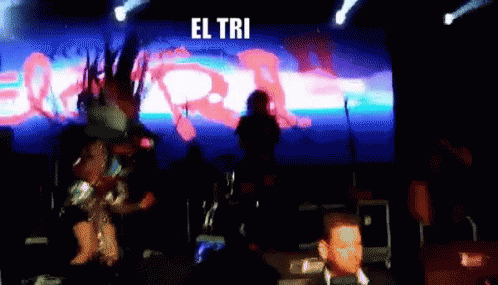 A Blurred Image Of A Stage With The Words El Tri Written On It GIF