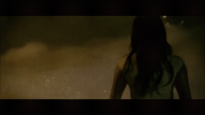 A Blurred Image Of A Woman Standing In A Pool Of Water GIF