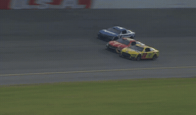 A Blurred Image Of Cars Racing On A Track With A Sign That Says Coca Cola GIF