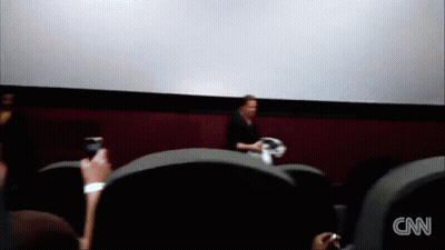 A Blurred Image Of People Watching A Movie With The Cnn Logo On The Bottom Left GIF