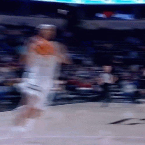 A Blurry Image Of A Basketball Player Dribbling A Ball GIF