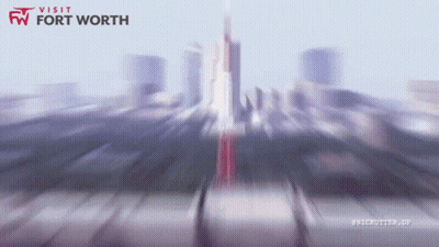 A Blurry Image Of A City With The Words Visit Fort Worth GIF