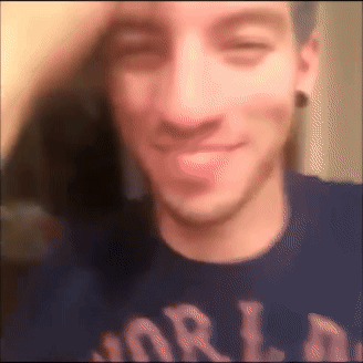 A Blurry Image Of A Man Wearing A Shirt That Says World GIF