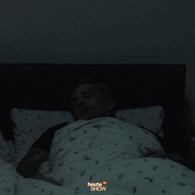A Blurry Photo Of A Man Laying In Bed With The Words " Heute " Written On The Bottom GIF