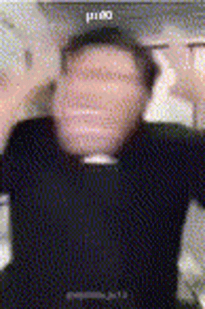 A Blurry Photo Of A Man Wearing A Black Shirt And A Black Hat GIF