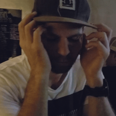 A Blurry Photo Of A Man Wearing A Hat That Says ' S ' On It GIF