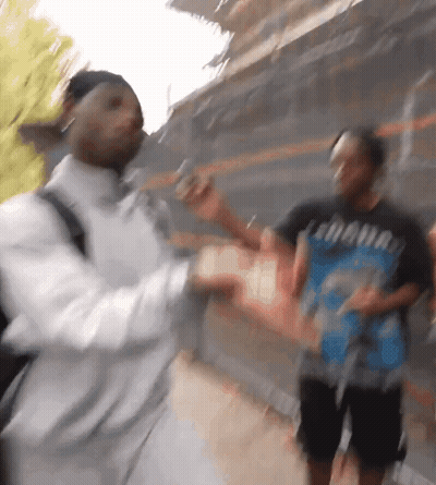 A Blurry Photo Of A Man Wearing A T-Shirt That Says ' Looney Tunes ' GIF