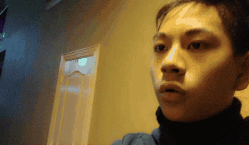 A Blurry Photo Of A Person 'S Face With A Door In The Background GIF