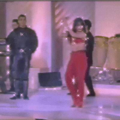 A Blurry Photo Of A Woman In Red Pants Dancing On A Stage GIF