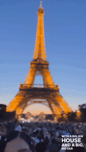 A Blurry Photo Of The Eiffel Tower With The Words With A Big Big House And A Big Big Car Below It GIF