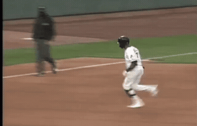 A Blurry Picture Of A Baseball Game With A Coca Cola Ad In The Background GIF