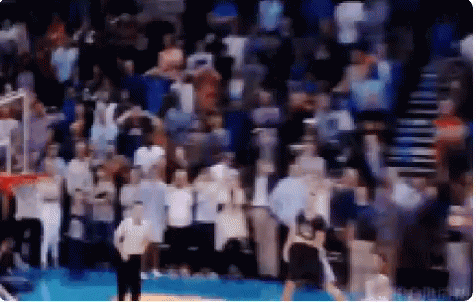 A Blurry Picture Of A Basketball Game With A Referee GIF