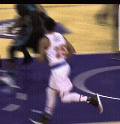 A Blurry Picture Of A Basketball Player Wearing Number 23 GIF