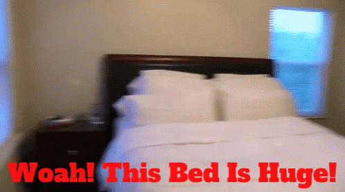 A Blurry Picture Of A Bed With The Words Woah This Bed Is Huge Above It GIF
