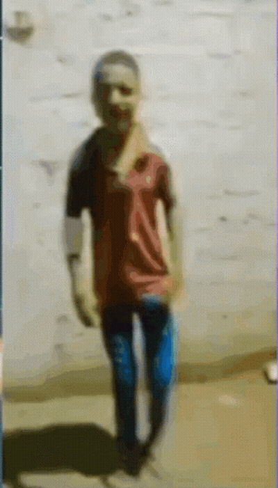A Blurry Picture Of A Boy In A Red Shirt GIF
