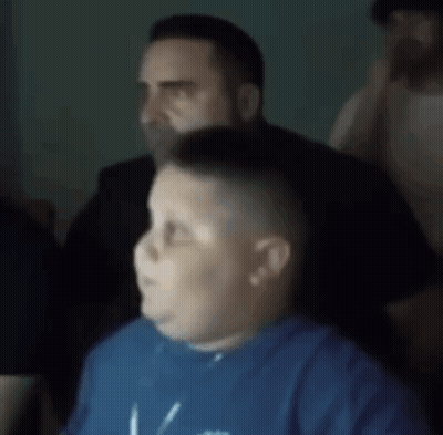 a blurry picture of a boy wearing a blue shirt that says ' i love you ' on it