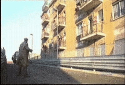 A Blurry Picture Of A Building With Balconies On The Side GIF