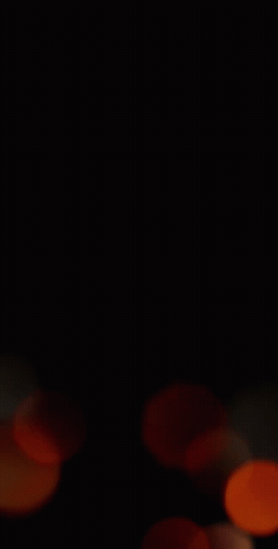 A Blurry Picture Of A Bunch Of Orange Circles On A Black Background . GIF